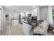 Spacious kitchen with bar seating, stainless steel appliances, and plenty of counter space at 691 Gulf Bay Rd, Longboat Key, FL 34228