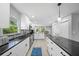 Bright kitchen features stainless steel appliances, sleek countertops, and ample cabinet space at 691 Gulf Bay Rd, Longboat Key, FL 34228