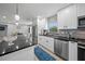 Well-lit kitchen with stainless steel appliances, modern fixtures, and a stylish backsplash at 691 Gulf Bay Rd, Longboat Key, FL 34228