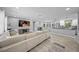 Spacious open-concept living room, featuring neutral colors, and hardwood floors connecting to a modern kitchen at 691 Gulf Bay Rd, Longboat Key, FL 34228