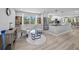 Open concept living room and kitchen with stainless steel appliances, natural light, and modern decor at 691 Gulf Bay Rd, Longboat Key, FL 34228