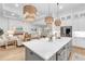 Stylish kitchen island with white countertops and stainless steel appliances, open to the dining and living area at 7717 Mainsail Ln, Sarasota, FL 34240