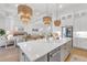 Kitchen featuring stainless steel appliances, an island, and an open concept view to the living room at 7717 Mainsail Ln, Sarasota, FL 34240