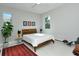 Airy bedroom features a minimalist design with a wooden bed frame and light-colored walls at 7744 Sandhill Lake Dr, Sarasota, FL 34241