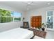 Bright bedroom features a large window with water views, a ceiling fan and decoratives at 7744 Sandhill Lake Dr, Sarasota, FL 34241
