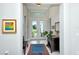 Bright foyer features tile flooring, an area rug, artwork, and French doors offering a glimpse of the outdoors at 7744 Sandhill Lake Dr, Sarasota, FL 34241
