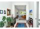 Elegant foyer with art, furniture, tile floors, an area rug, and an open view of the living spaces at 7744 Sandhill Lake Dr, Sarasota, FL 34241