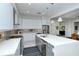 Modern kitchen with sleek white cabinets, stainless steel appliances, and large center island at 7744 Sandhill Lake Dr, Sarasota, FL 34241