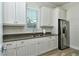 Clean kitchen featuring white cabinets, stainless steel appliances, and a functional layout at 7744 Sandhill Lake Dr, Sarasota, FL 34241