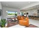 Open-concept living room features a seamless flow into the kitchen and access to an outdoor living space at 7744 Sandhill Lake Dr, Sarasota, FL 34241