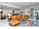 Bright and airy living room with leather seating, view of the open-concept kitchen and modern decor at 7744 Sandhill Lake Dr, Sarasota, FL 34241