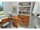 Office nook with built in shelving, drawers, a desktop, artwork and chair at 7744 Sandhill Lake Dr, Sarasota, FL 34241