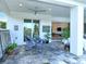 Charming covered patio featuring an outdoor dining table and tiled floor at 7744 Sandhill Lake Dr, Sarasota, FL 34241