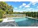 Sparkling pool is surrounded by a well-manicured landscape, offering a serene and private outdoor experience at 7744 Sandhill Lake Dr, Sarasota, FL 34241