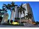 Alinari condo exterior with palm trees, landscaping, and building signage at 800 N Tamiami Trl # 1506, Sarasota, FL 34236