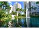 Elegant condominium complex with lush landscaping, water features, and a serene ambiance at 800 N Tamiami Trl # 1506, Sarasota, FL 34236