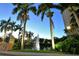 Picturesque view of lush landscaping, a water feature, and a building at night at 800 N Tamiami Trl # 1506, Sarasota, FL 34236