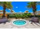 Outdoor hot tub surrounded by lush landscaping and mature palm trees on a beautiful sunny day at 800 N Tamiami Trl # 1506, Sarasota, FL 34236