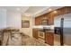 Modern kitchen featuring granite countertops and stainless steel appliances at 800 N Tamiami Trl # 1506, Sarasota, FL 34236