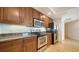 Kitchen with wooden cabinets, granite counters, and stainless appliances at 800 N Tamiami Trl # 1506, Sarasota, FL 34236