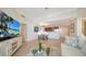 Open floorplan living room with a view, tile flooring, and modern furnishings at 800 N Tamiami Trl # 1506, Sarasota, FL 34236