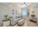 Cozy living room with a comfortable sofa, desk area, and a large window providing natural light at 800 N Tamiami Trl # 1506, Sarasota, FL 34236