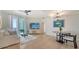 Sun-filled living room with access to a balcony and a dining area at 800 N Tamiami Trl # 1506, Sarasota, FL 34236