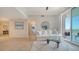 Bright living room featuring tile floors, a comfortable couch, and balcony access at 800 N Tamiami Trl # 1506, Sarasota, FL 34236