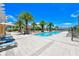 Inviting community pool area with lounge chairs, sun umbrellas, and surrounding landscaping, perfect for relaxation at 800 N Tamiami Trl # 1506, Sarasota, FL 34236