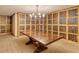 Elegant wine cellar with custom shelving, a large table, and ample storage for wine collections at 800 N Tamiami Trl # 1506, Sarasota, FL 34236