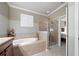 Elegant bathroom with a large soaking tub and separate glass-enclosed shower at 8007 River Preserve Dr, Bradenton, FL 34212