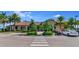 Inviting community clubhouse featuring a well-manicured landscape, sidewalks, and ample parking at 8007 River Preserve Dr, Bradenton, FL 34212