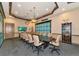 Community conference room with a large table, rolling chairs, flat screen tv, and decorative lighting at 8007 River Preserve Dr, Bradenton, FL 34212