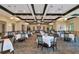 Expansive dining room with set tables, elegant decor, and ample space for guests at 8007 River Preserve Dr, Bradenton, FL 34212