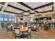 Spacious dining room with tables, chairs, large windows, and a bar area at 8007 River Preserve Dr, Bradenton, FL 34212