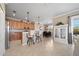 Open kitchen with wooden cabinets, bar seating, and a seamless transition to the adjacent dining area at 8007 River Preserve Dr, Bradenton, FL 34212