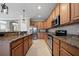 Gourmet kitchen featuring stainless steel appliances, granite counters, and wooden cabinetry at 8007 River Preserve Dr, Bradenton, FL 34212
