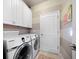 Convenient laundry room featuring a washer, dryer, and plenty of cabinet space at 8007 River Preserve Dr, Bradenton, FL 34212