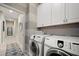 Functional laundry room with modern washer and dryer units and ample storage at 8007 River Preserve Dr, Bradenton, FL 34212