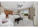 Bright living room boasts neutral tones, a ceiling fan, white sofas, and sliding doors to outdoor pool area at 8007 River Preserve Dr, Bradenton, FL 34212