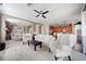 This living room opens to the kitchen and features ample seating and a ceiling fan at 8007 River Preserve Dr, Bradenton, FL 34212