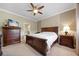 Spacious bedroom with a ceiling fan, ensuite bathroom, and a dark wood bedroom set at 8007 River Preserve Dr, Bradenton, FL 34212