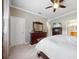 Bright bedroom featuring a dresser and a doorway leading to the primary ensuite bath at 8007 River Preserve Dr, Bradenton, FL 34212