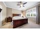 Comfortable bedroom with a ceiling fan, large window and natural light at 8007 River Preserve Dr, Bradenton, FL 34212