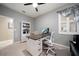 Well-lit home office with modern desk, chair, and storage shelving at 8007 River Preserve Dr, Bradenton, FL 34212