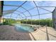 Inviting screened-in pool and spa with a brick-paved patio and lush landscaping at 8007 River Preserve Dr, Bradenton, FL 34212