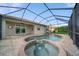 Sparkling pool and spa area with brick pavers, enclosed by a screened lanai at 8007 River Preserve Dr, Bradenton, FL 34212