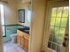 Bathroom featuring sleek vanity, round mirror, and neutral wall colors at 810 Hammockwood Ct, Sarasota, FL 34232