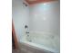 Clean white tiled bathtub and shower combo, great for relaxing and unwinding at 810 Hammockwood Ct, Sarasota, FL 34232