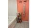 Close up of bathtub and shelves with personal care items in a bright colored bathroom at 810 Hammockwood Ct, Sarasota, FL 34232